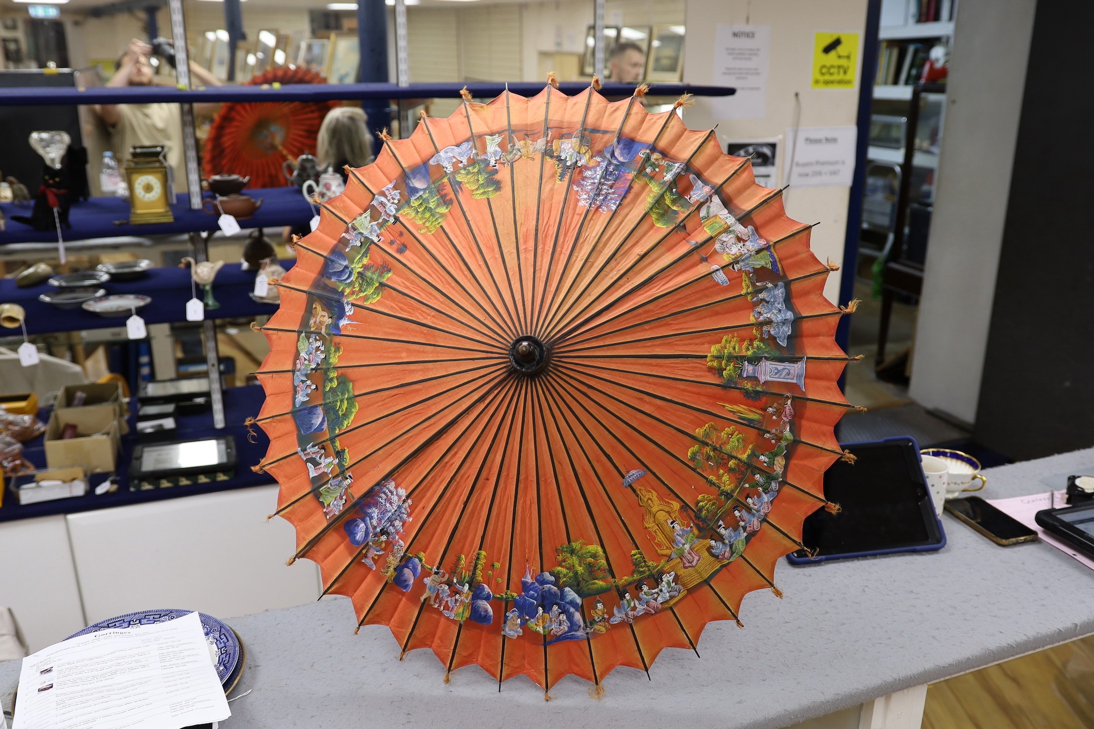 A Burmese painted parasol with white metal handle, 62cm, and one other parasol